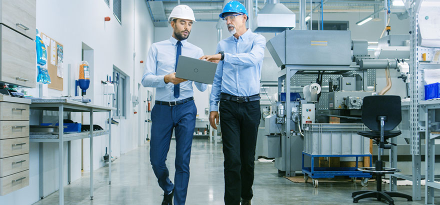 two person walking in a factory office